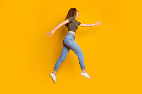 Photo of cheerful excited cute girl stylish clothes running fast hurrying seasonal sale hot offer isolated on yellow color background