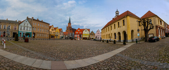 view of Holy Mary gothic church from old market square Trzebiatow, Poland - obrazy, fototapety, plakaty