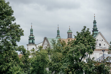 Fototapeta na wymiar Historic Church Spires Above Treetops in Krakow