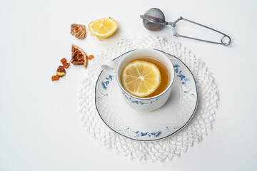 Still life with fine porcelain tea cups and accessories on a textured white background - 764139225
