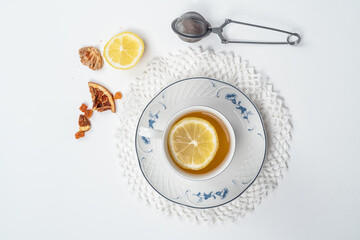 Still life with fine porcelain tea cups and accessories on a textured white background - 764139499