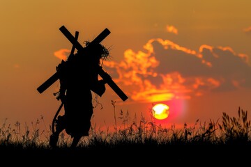 Fototapeta na wymiar Jesus Christ silhouette carrying the cross against a sunset background.