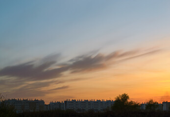 Silhouettes of houses at dusk against a beautiful evening sky at sunset