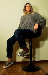 pretty woman sitting on a stool