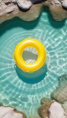 Yellow inflatable ring on clear beautiful water. Summer time concept. Template, copy space, rest, vacation.