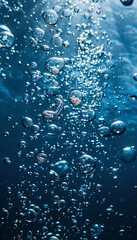 Deep ocean view of hundreds of bubbles rising to the surface