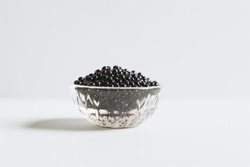 bowl of black caviar isolated on white backgrond, close up