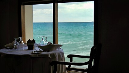 table in the restaurant with the Indian Ocean directly net to the window