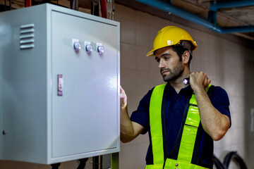 Electrical engineer working in control room. Electrical engineer man checking Power Distribution...