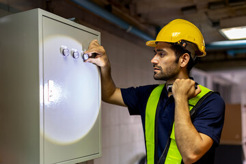 Electrical engineer working in control room. Electrical engineer man checking Power Distribution...