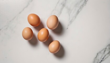 Aerial view of raw eggs on a white marble table
