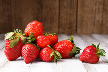 Berries of fresh organic strawberries on a wooden background.