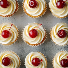 looking down on cupcakes with white chocolate and maraschino cherry toppings - obrazy, fototapety, plakaty
