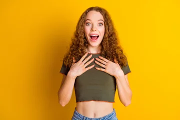 Foto op Canvas Photo of excited positive woman hands touch chest open mouth shout.wow unexpected victory isolated on vibrant yellow color background © deagreez