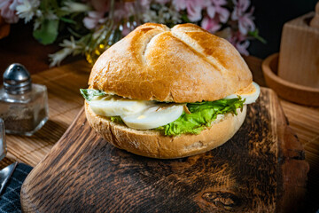 Sandwich with lettuce and boiled egg.