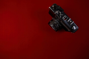 Top view of retro camera on red background with copy space Flat lay