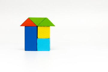 House made of old cubes. Wooden colorful building blocks isolated on white background. Vintage children toys.