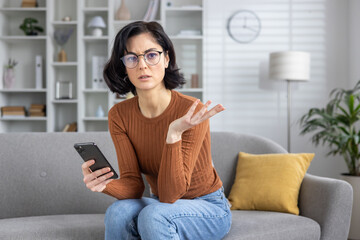 Confused woman receiving bad news via text message