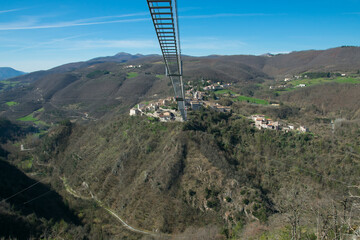 Panoramic view of Sellano's Tibetan bridge, adrenaline and excitement in the heart of Umbria region, Italy - 764179224