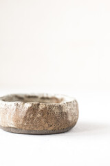 Old clay bowl on a white background.