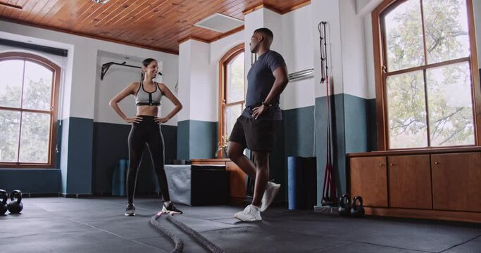 A man and a woman workout in a gym doing exercises