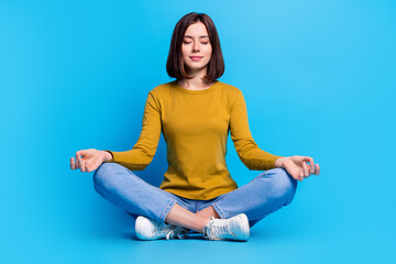Full length photo of cute shocked woman wear shirt closed eyes enjoying yoga isolated blue color background