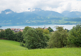 view to Sigriswil tourist resort and cloudy Bernese Alps landscape