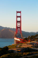 View of Golden Gate Bridge at golden hour with a clear sky. Beautiful and relaxing sunset in San...