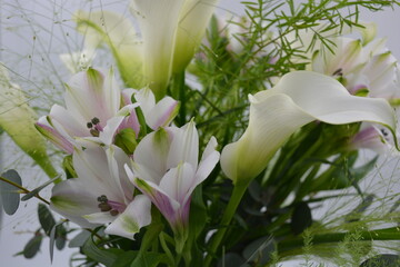 A beautiful, festive bouquet, composition of white calla lilies, purple white orchids, flowers,...