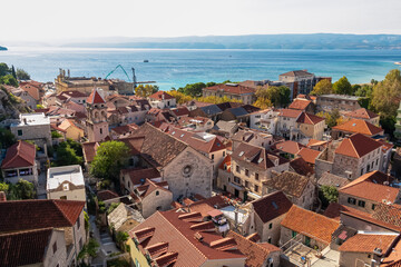 Aerial view of old centre of coastal town Omis in Split-Dalmatia, Croatia, Europe. Majestic coastline of Omis Riviera at Adriatic Sea in Balkans. Summer travel destination. Viewpoint from Peovica fort