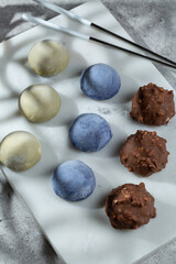 Mochi cakes of three flavors on a stone board