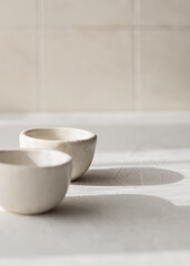 two ceramic tea bowls. Ceramic saucepan for handmade sauce. Minimalism style. Front view. Japanese...