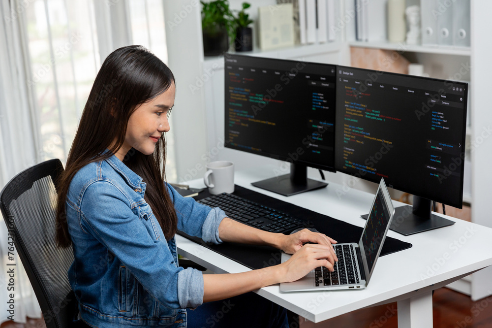 Wall mural smiling young asian in it developer creating with typing online information on laptop with coding pr