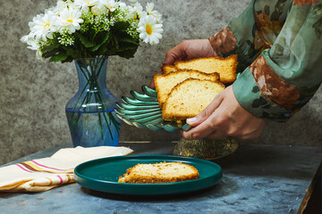 woman hand holding homemade pound cake, daisy flowers