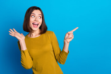 Photo of shocked impressed woman wear shirt open mouth looking showing finger empty space isolated...