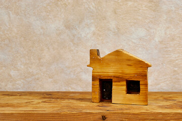 Obraz na płótnie Canvas mini wooden house model on wooden table. Planning to buy property. Choose what's the best concept