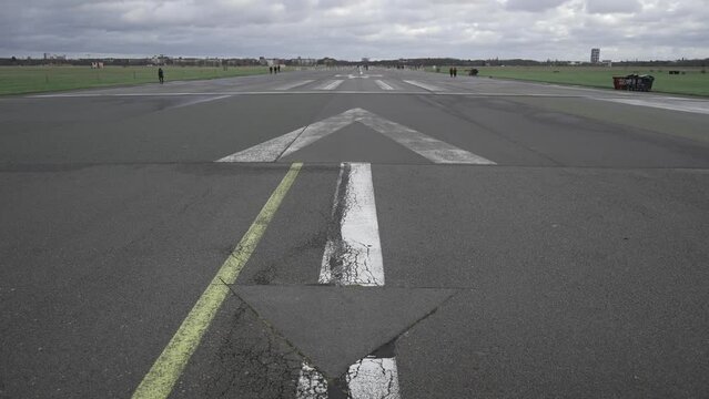 Berlin, Germany. Flughafen Berlin-Tempelhof. Unused old airport transformed into public space. People walk, ride bicycles on empty runways in Tempelhofer Feld. Tempelhofer Feld. 