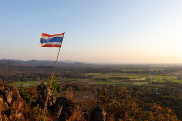 Flag of the Kingdom of Thailand waiving on the hill in Northern Thailand near Chiang Mai. - obrazy, fototapety, plakaty