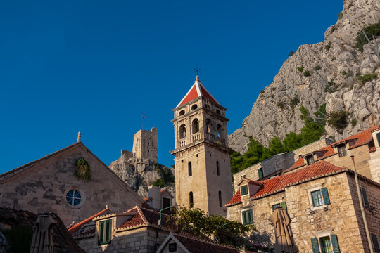 Scenic view of Saint Michael church and Mirabela Fortress (Peovica) in old town of Omis, Split-Dalmatia, South Croatia, Europe. Mediterranean architecture landmark surrounded by steep Dinara mountains