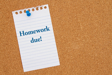 Homework Due message on lined rule paper on corkboard