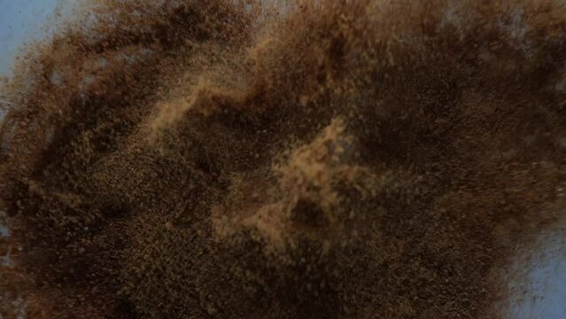 Brown powder floating in the air in slow motion