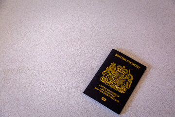 New British passport of post-Brexit blue black UK passport cover with against light background