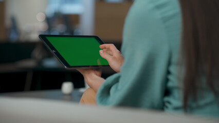 Leader fingers swiping mockup tablet at office closeup. Woman scrolling device