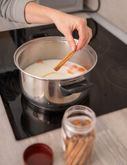 Preparing Spiced Milk with Cinnamon Stick