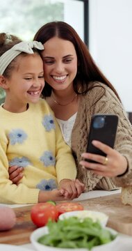 Mother, daughter and selfie in home with cooking for profile picture update, social media post or memories. Family, woman or child with photo for bonding or preparing vegetables with smile in kitchen