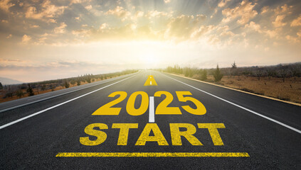 The beginning of the new year 2025. The word 2025 written on the asphalt road at sunrise. The...