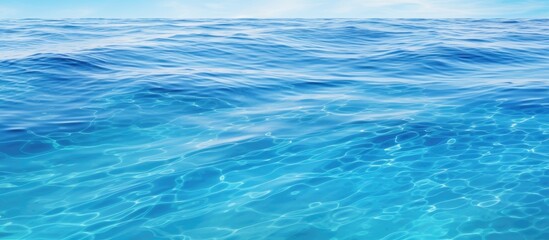 A serene blue ocean under a bright sun with gentle waves rippling on the surface