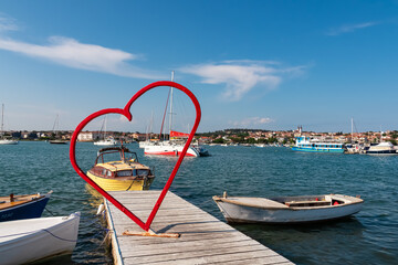 Red heart shaped landmark at idyllic port of coastal town Medulin, Istria peninsula, Croatia,...