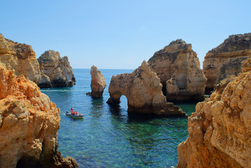People on the boats enjoying a summer day at the magical Ponta da Piedade in the South of Portugal,...