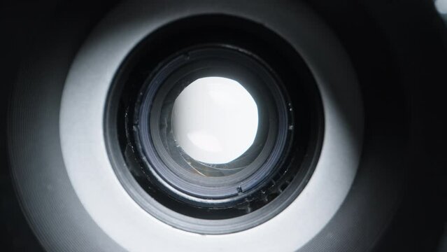 Diaphragm aperture smoothly widens, macro view inside the optical device.
